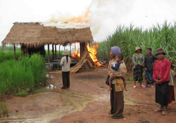 2009년 10월 콘 크리엘 코뮌의 오배트 신음 마을에서 마을 사람들이 강제 퇴거 중 농가가 불타는 것을 지켜보고 있다.